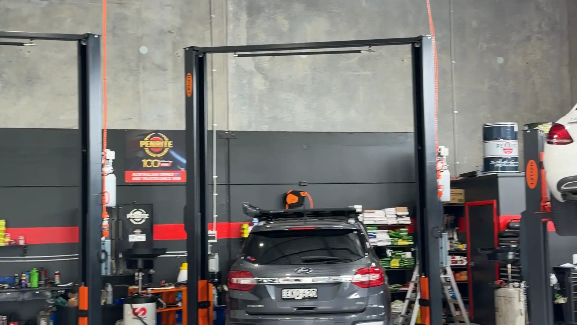 Inside the SAI Motor Works workshop in Rutherford, with cars on hoists
