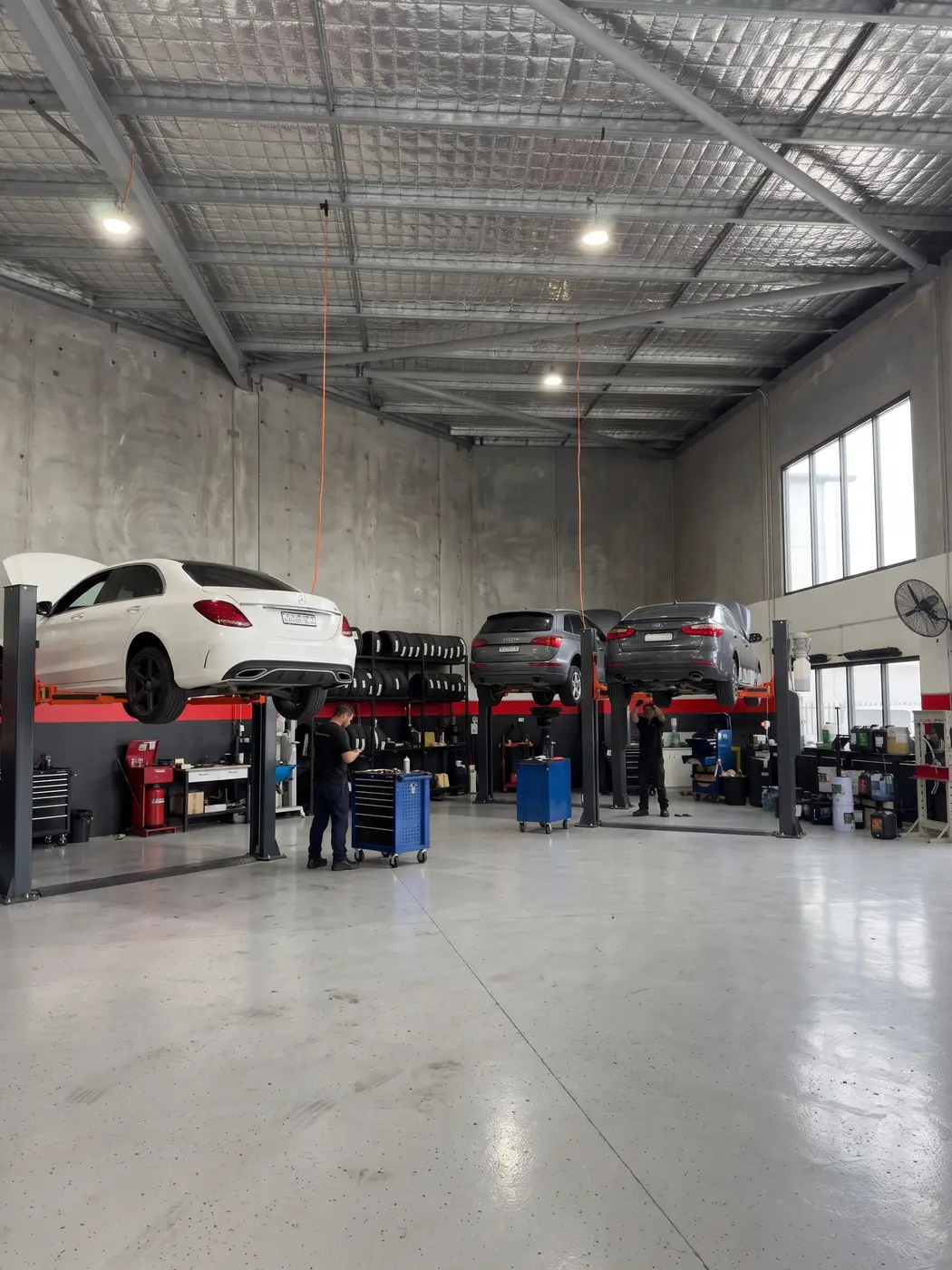 SAI Motor Works workshop floor with cars on hoists