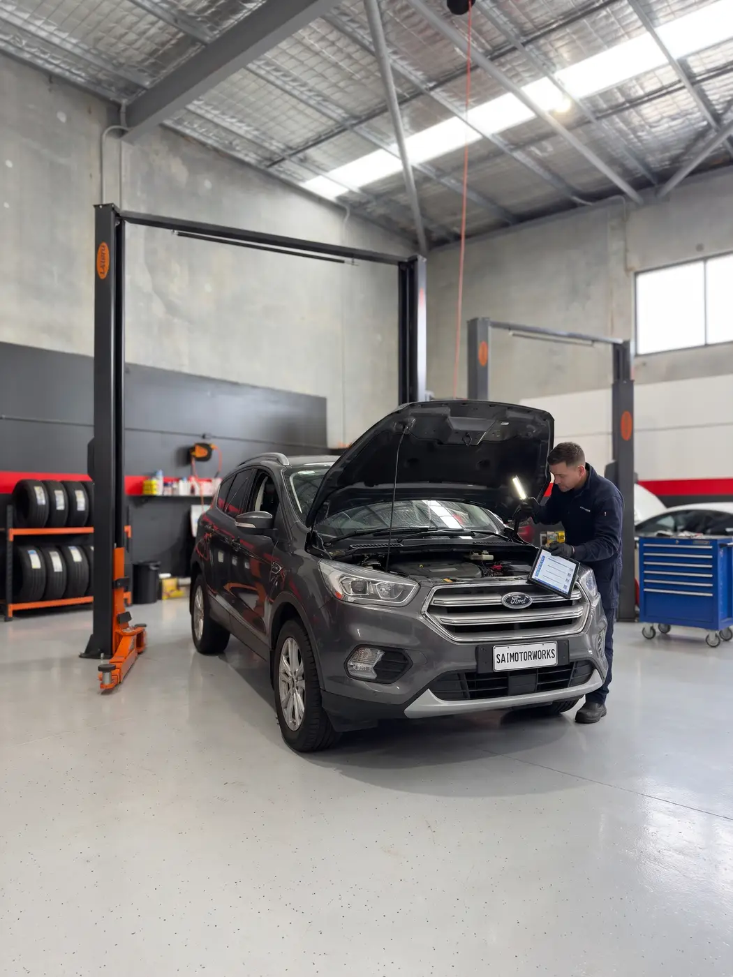 Mechanic inspecting an SUV with a tablet before purchase